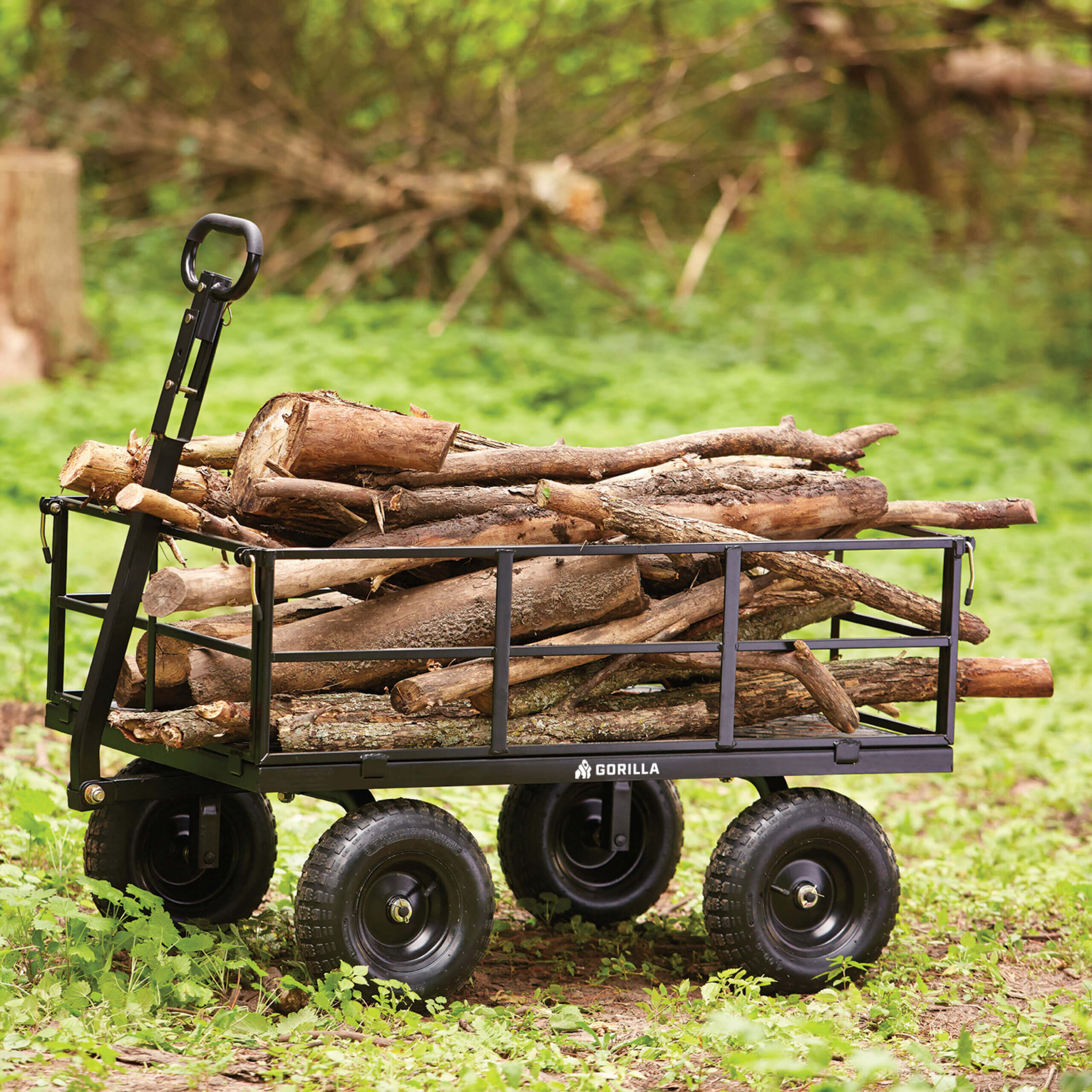 Black Gorilla cart loaded with wooden logs on a grassy background.