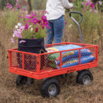 Red Gorilla utility cart carrying flowers and bags in a field, marked "GORILLA."