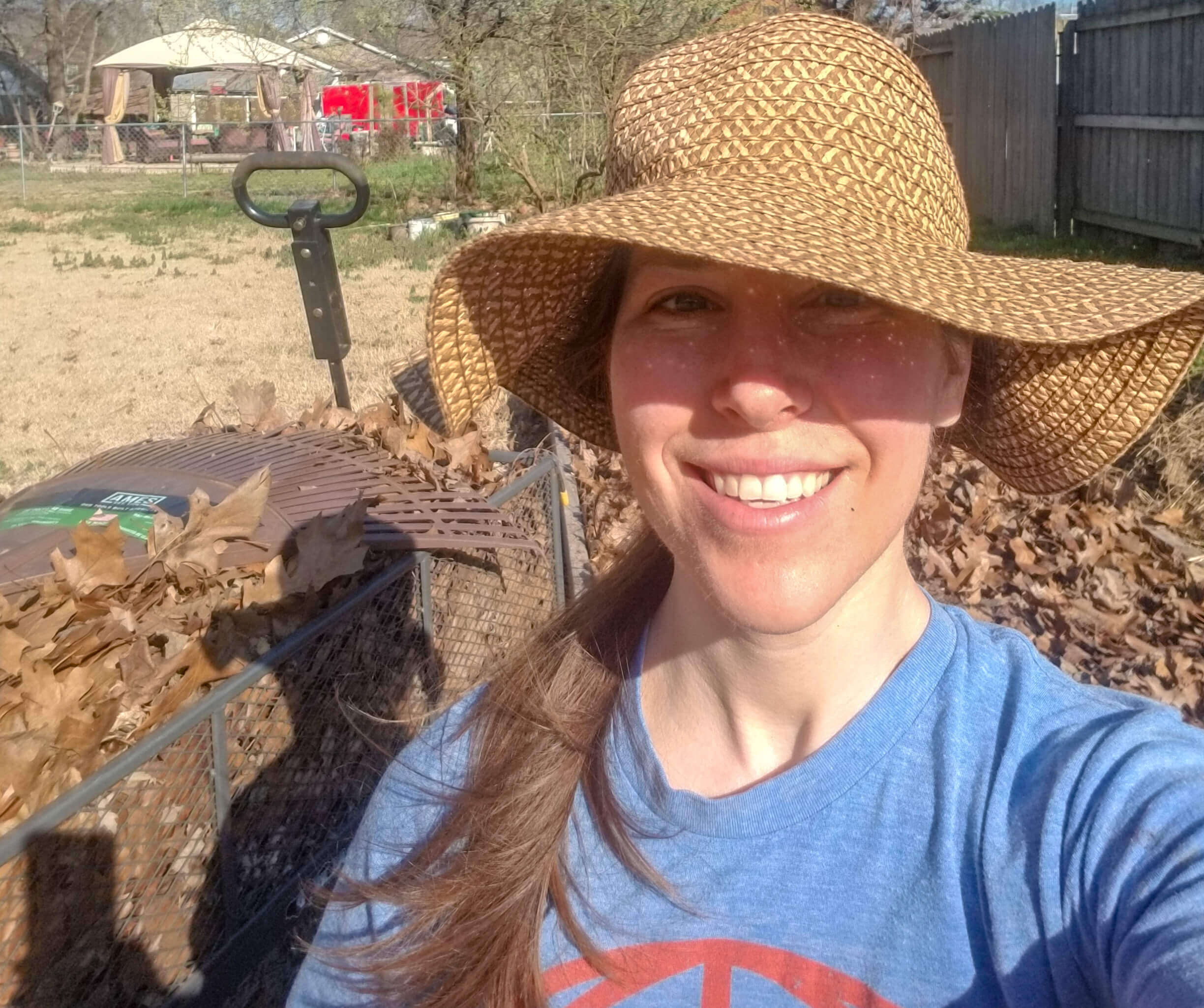 Woman taking a picture in front of her garden