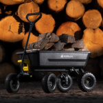 Gorilla Made black utility cart loaded with firewood, stacked logs in the background.