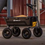 Black Gorilla cart loaded with corn, featuring sturdy wheels and a yellow holder.
