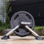 Gorilla Made hose reel with a black wheel and silver stand on a wet patio surface.