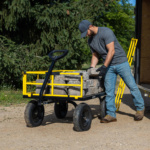 Gorilla Made heavy-duty cart with yellow rails, loaded with large stones.