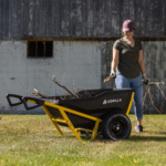 Person using Gorilla Made black and yellow utility cart filled with branches.