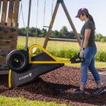Person using a Gorilla Made utility cart with a yellow frame and black tires.