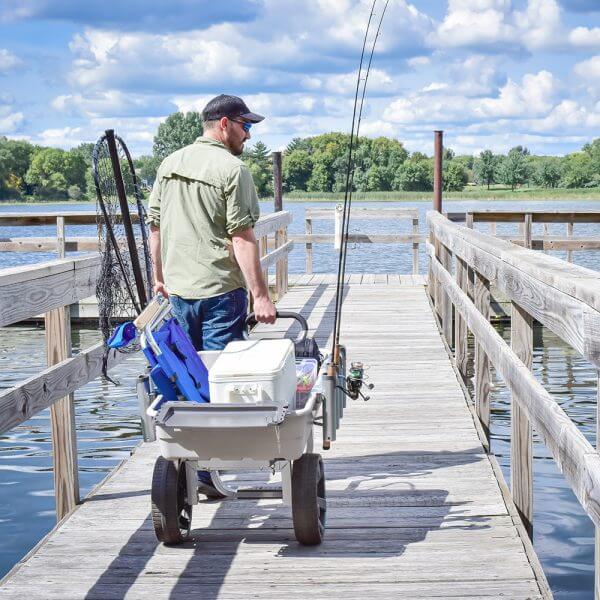 man pulling GCO-5FSH on a dock filled with fishing gear