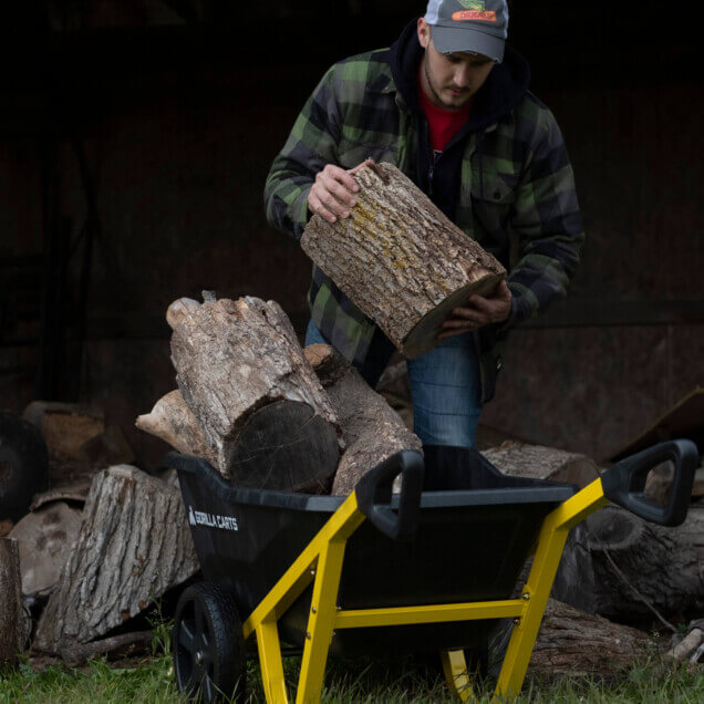 man placing a wood log into a GCR-7