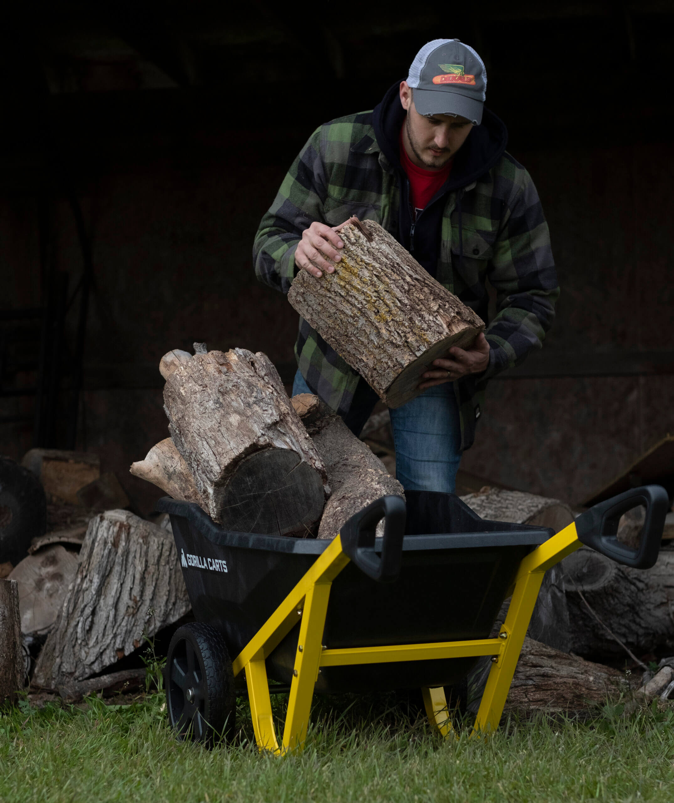 man placing a wood log into a GCR-7
