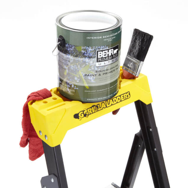 Yellow Gorilla Ladders with "BEHR" paint can, brush, and red cloth on top.