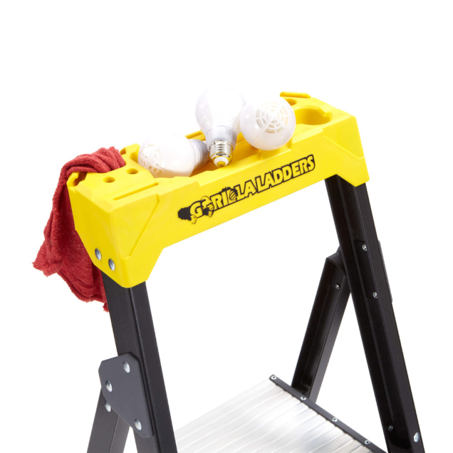 Yellow Gorilla Ladders top with light bulbs and red cloth placed on it.