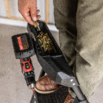 Person holding screws on a Gorilla Made ladder with a drill and tray of screws.