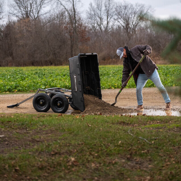 a man from distance pulling dirt out of a GOR-10H