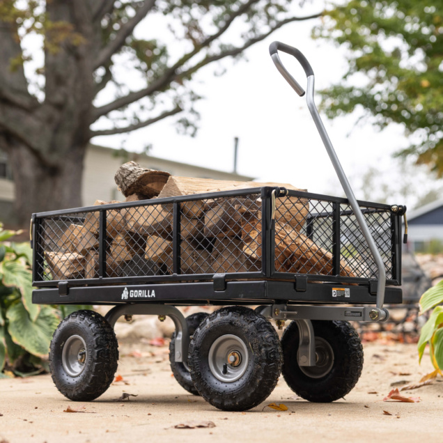 Gorilla Made utility cart carrying firewood, black metal frame, silver handle.