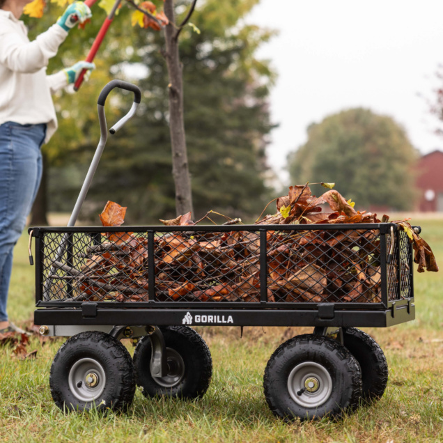 Gorilla Made utility cart loaded with fallen leaves, sturdy black metal frame.