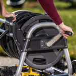 Close-up of hands operating Gorilla Made hose reel crank.
