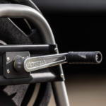Close-up of a metal Gorilla Made hose reel crank with gray handle and frame.