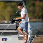 Person on a boat using a Gorilla Made garden hose with a Cobalt logo visible.
