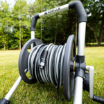 Gorilla ToughLite hose reel with gray reel and metal frame on grass.