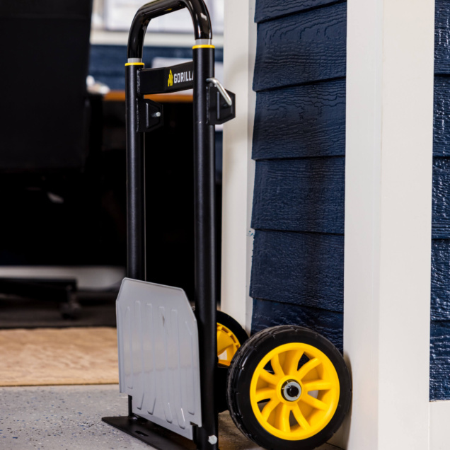 Gorilla Made hand truck with black frame, silver plate, and yellow wheels.