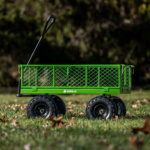 Green Gorilla utility cart with thick black wheels on grass, ideal for tough tasks.