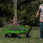 Green Gorilla Made cart with branches and tools, on grass.
