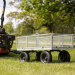 Gray Gorilla utility cart with metal mesh sides and black wheels on grass.