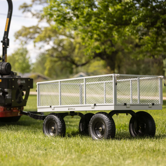 Gray Gorilla utility cart with metal mesh sides and black wheels on grass.