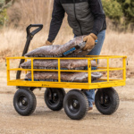 Yellow Gorilla utility cart loaded with mulch bags being moved on a dirt path.