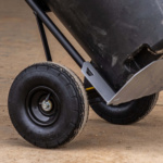 Close-up of a Gorilla Made heavy-duty cart wheel on a concrete surface.