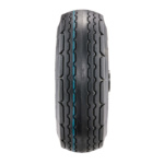 Front view of a Gorilla Made tire with solid black tread and blue center stripe.