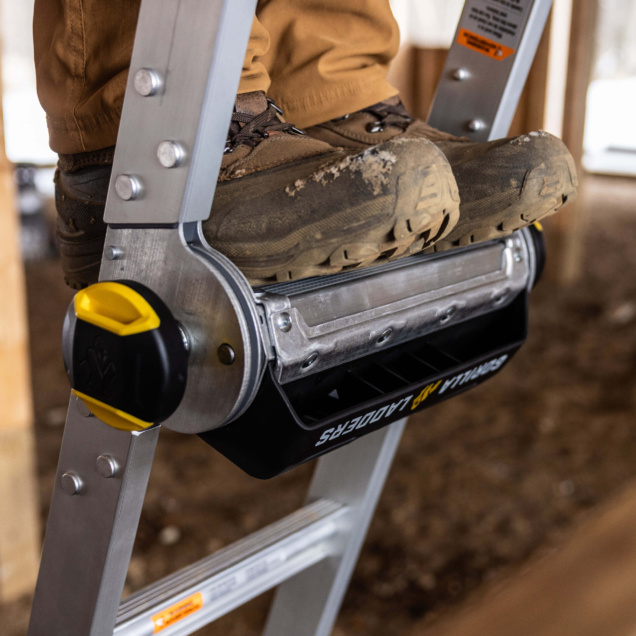 Close-up of boots on the Gorilla Made ladder with a sturdy metal build.