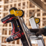 Close-up of a Gorilla Ladders ladder with a red and black drill attached.