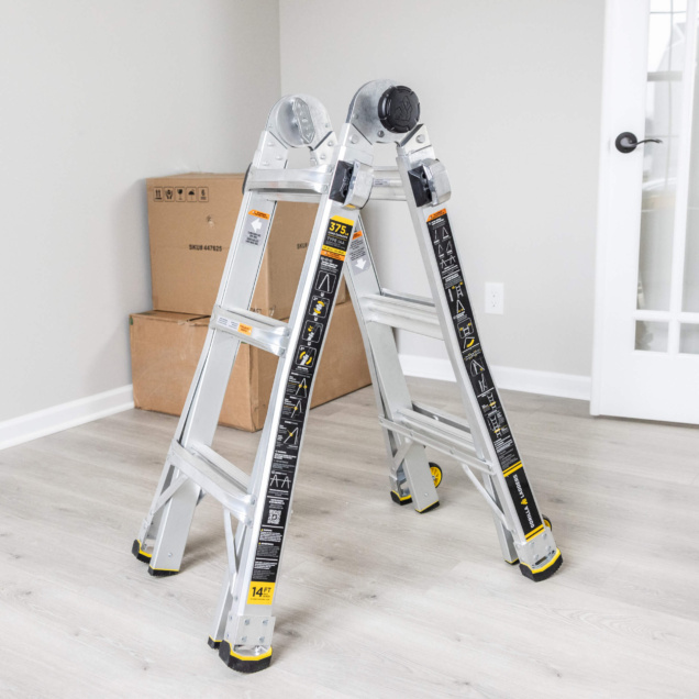 GMPX ladder, silver, 14 feet high, 375 lbs capacity, in a room with boxes.