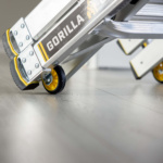 Silver ladder with "GORILLA" text on side, featuring yellow and black wheels.