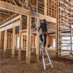 Person climbing a Gorilla Made ladder inside a wooden construction frame.