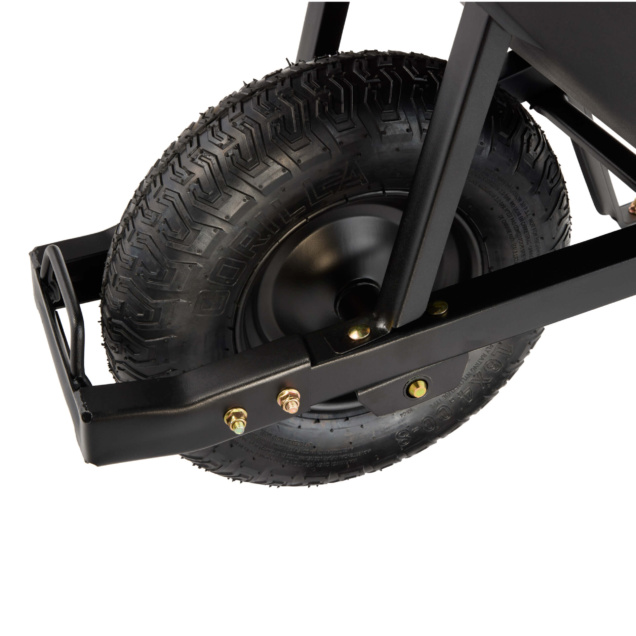 Close-up of a Gorilla Made heavy-duty wheelbarrow tire, showcasing tread and metal frame.