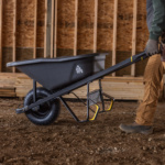 Heavy-duty black wheelbarrow by Gorilla Made on a construction site.