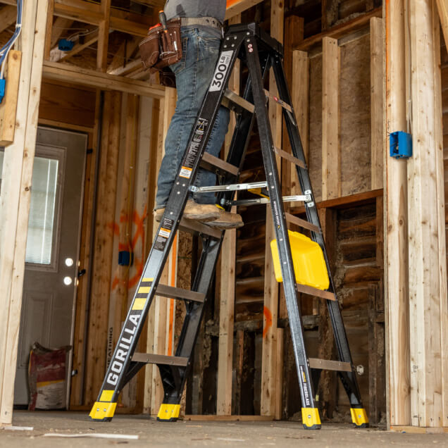 Gorilla heavy-duty ladder in use at a construction site, marked "300 LB".