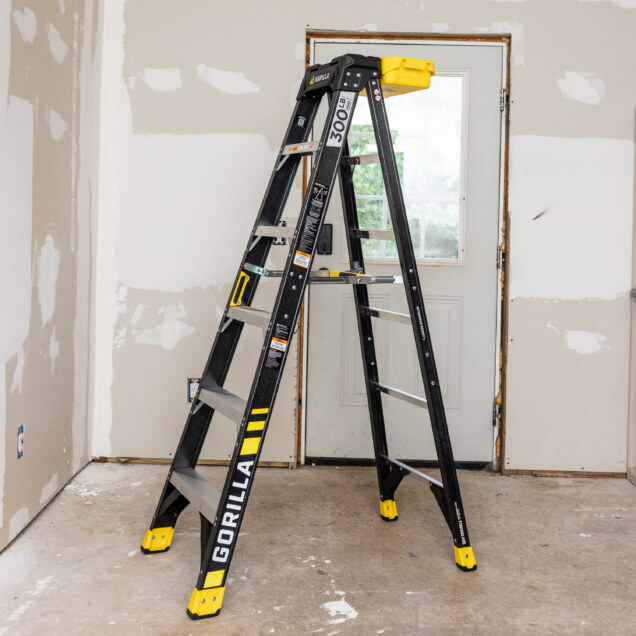 Gorilla Made GF300 black ladder with yellow accents, 300 lb capacity, indoors.