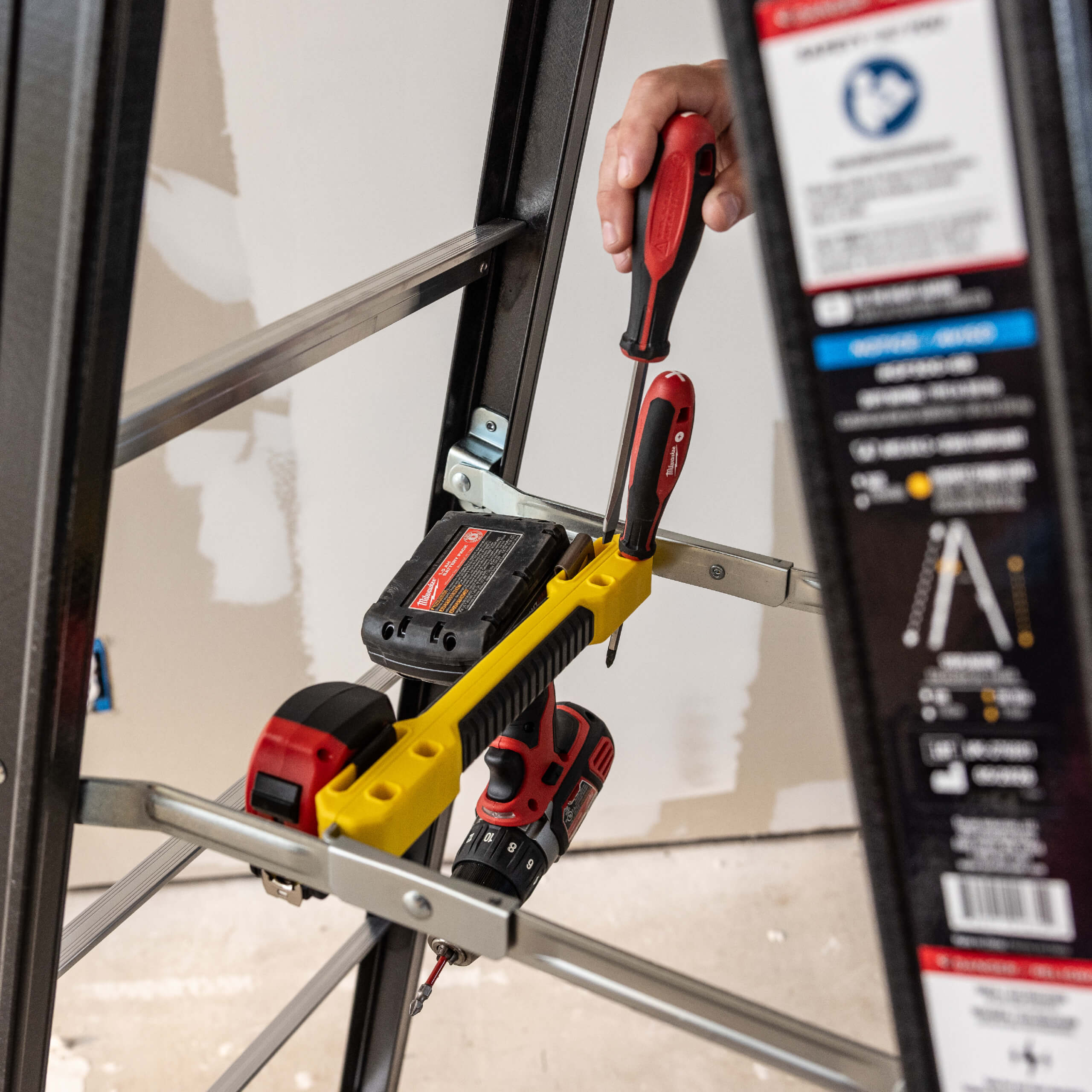 GF300 ladder with black frame, yellow tool holder, red tools, and safety instructions.