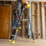 Gorilla Made ladder with "GF300" label; holds person working indoors.