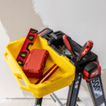 GF300 6B ladder with a yellow tool tray holding a red level and toolkit.