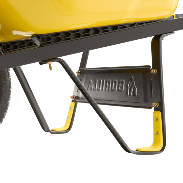 Close-up of a yellow Gorilla Made wheelbarrow, black frame, and engraved panel.
